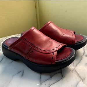 Platform Dansko’s, red slip on sandals with stitching details.